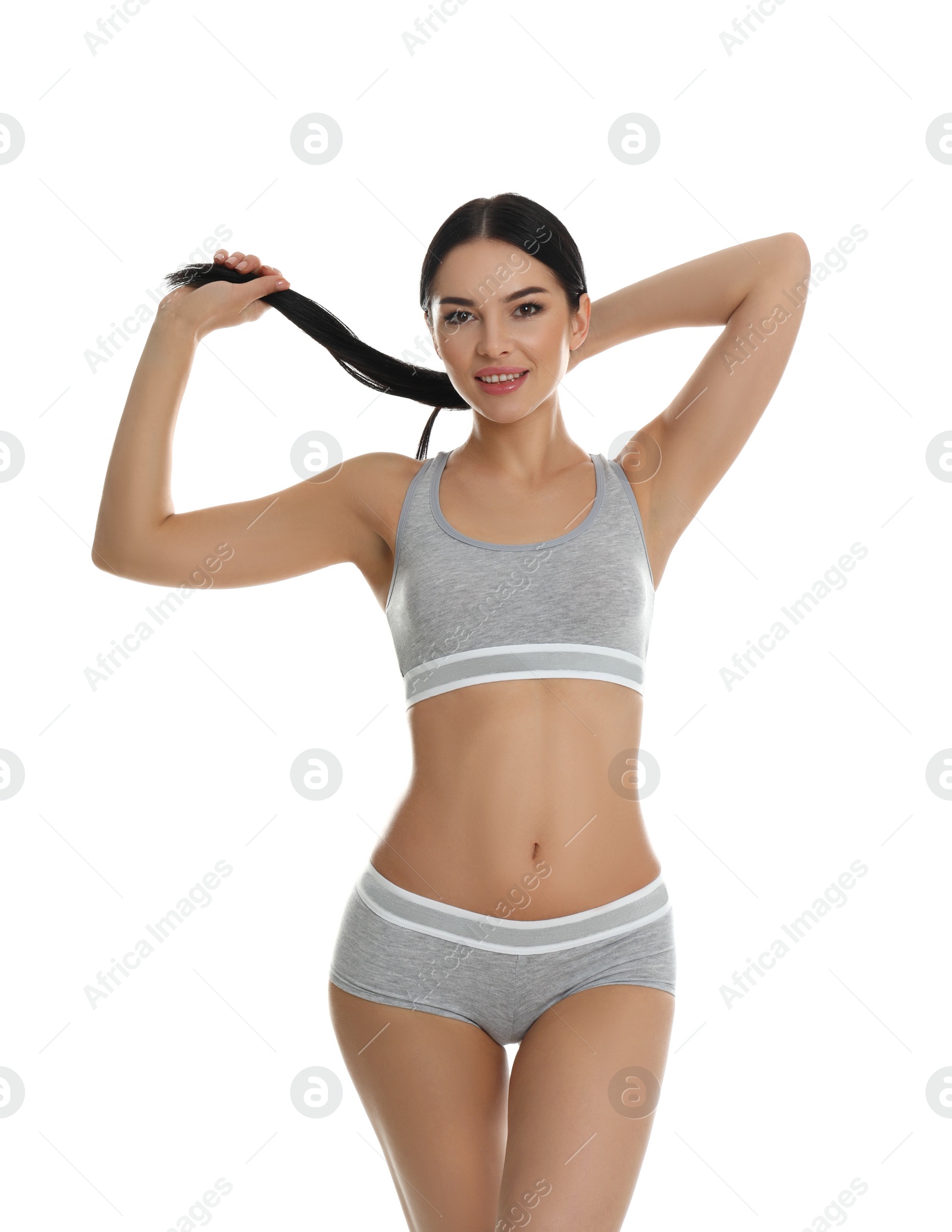 Photo of Beautiful young woman in grey sportive underwear isolated on white