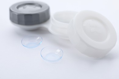Photo of Contact lenses and case on white background, closeup