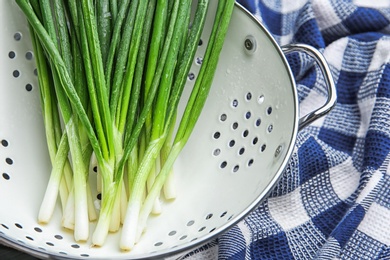 Photo of Colander with fresh green onion, closeup