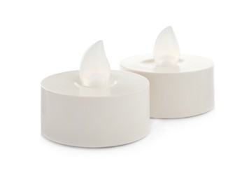 Photo of Decorative flameless LED candles on white background