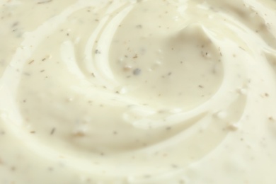 Photo of Tasty homemade garlic sauce as background, closeup