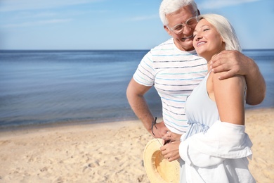 Photo of Mature couple spending time together on sea beach