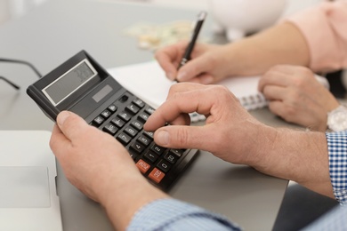 Photo of Mature couple thinking over pension payment at home, closeup