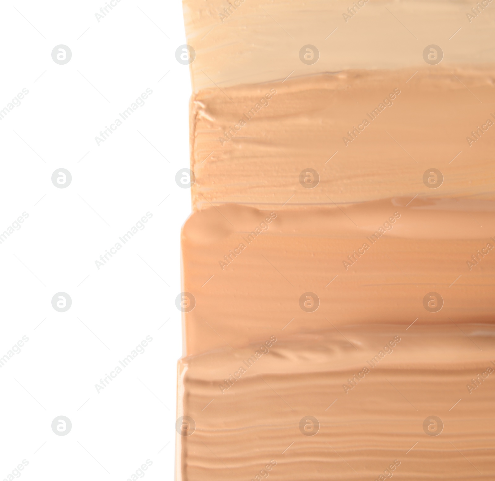 Photo of Samples of different foundation shades on white background, top view