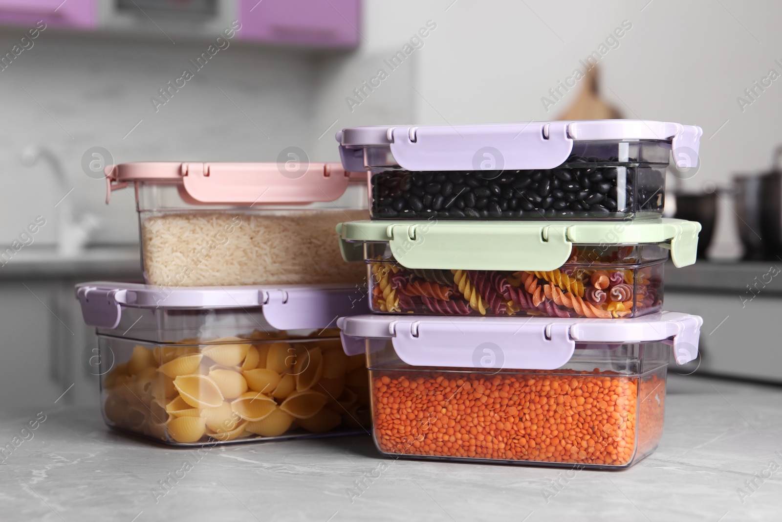 Photo of Many boxes with different food on table in kitchen