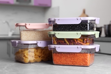 Photo of Many boxes with different food on table in kitchen