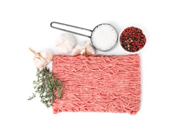 Fresh raw ground meat, spices, garlic and thyme isolated on white, top view