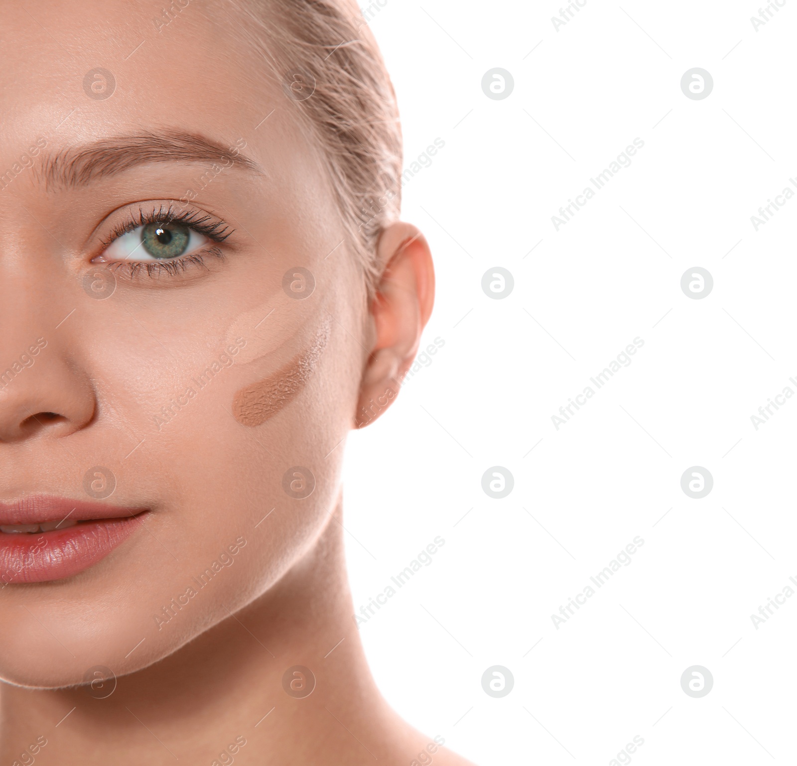 Photo of Young woman with different shades of skin foundation on her face against white background, closeup