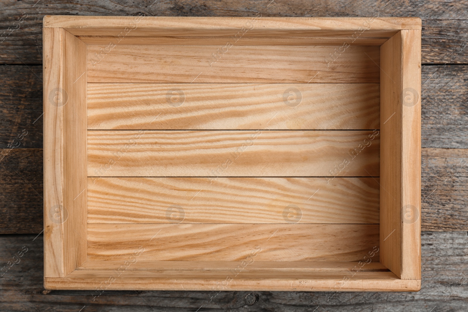 Photo of Empty crate on wooden background, top view