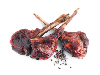 Photo of Pieces of delicious grilled beef meat and peppercorns isolated on white, top view