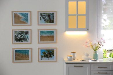 Photo of Stylish kitchen interior with beautiful artworks on wall