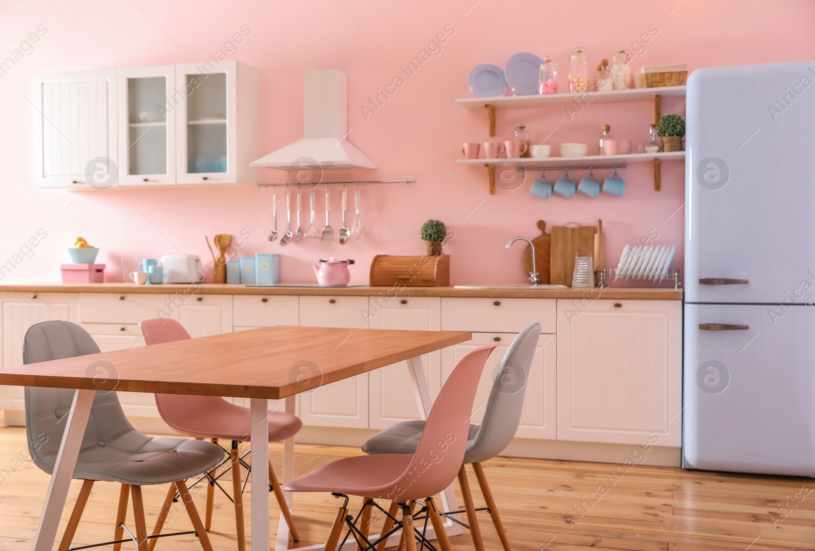 Photo of Stylish kitchen interior with dining table and chairs