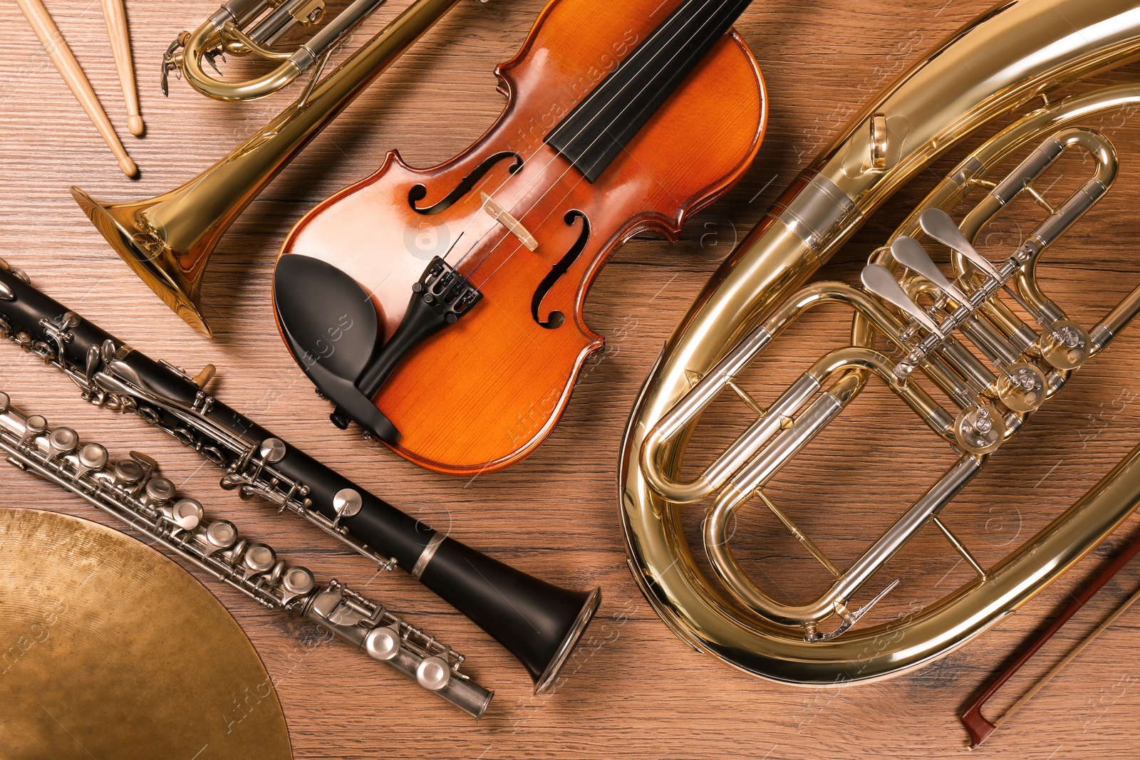 Photo of Set of different musical instruments on wooden background, flat lay