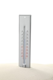 Photo of Weather thermometer in sand against white background