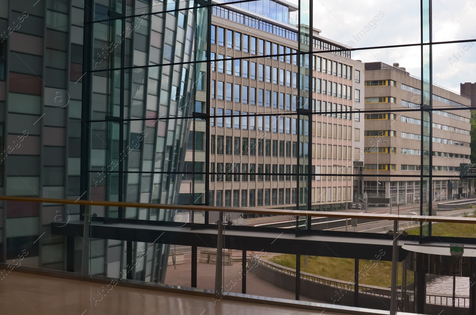 Photo of Beautiful city street with buildings, view through big glass windows