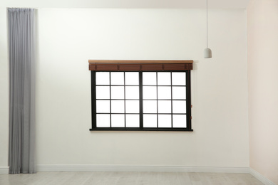 Photo of Window with open blinds in empty room