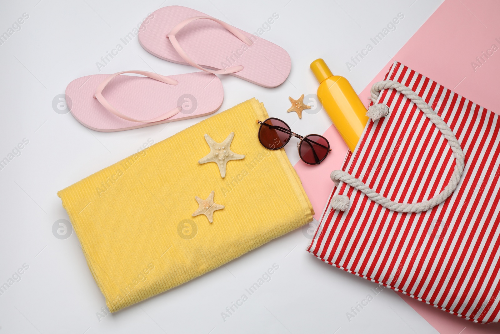 Photo of Stylish bag and beach accessories on color background, flat lay