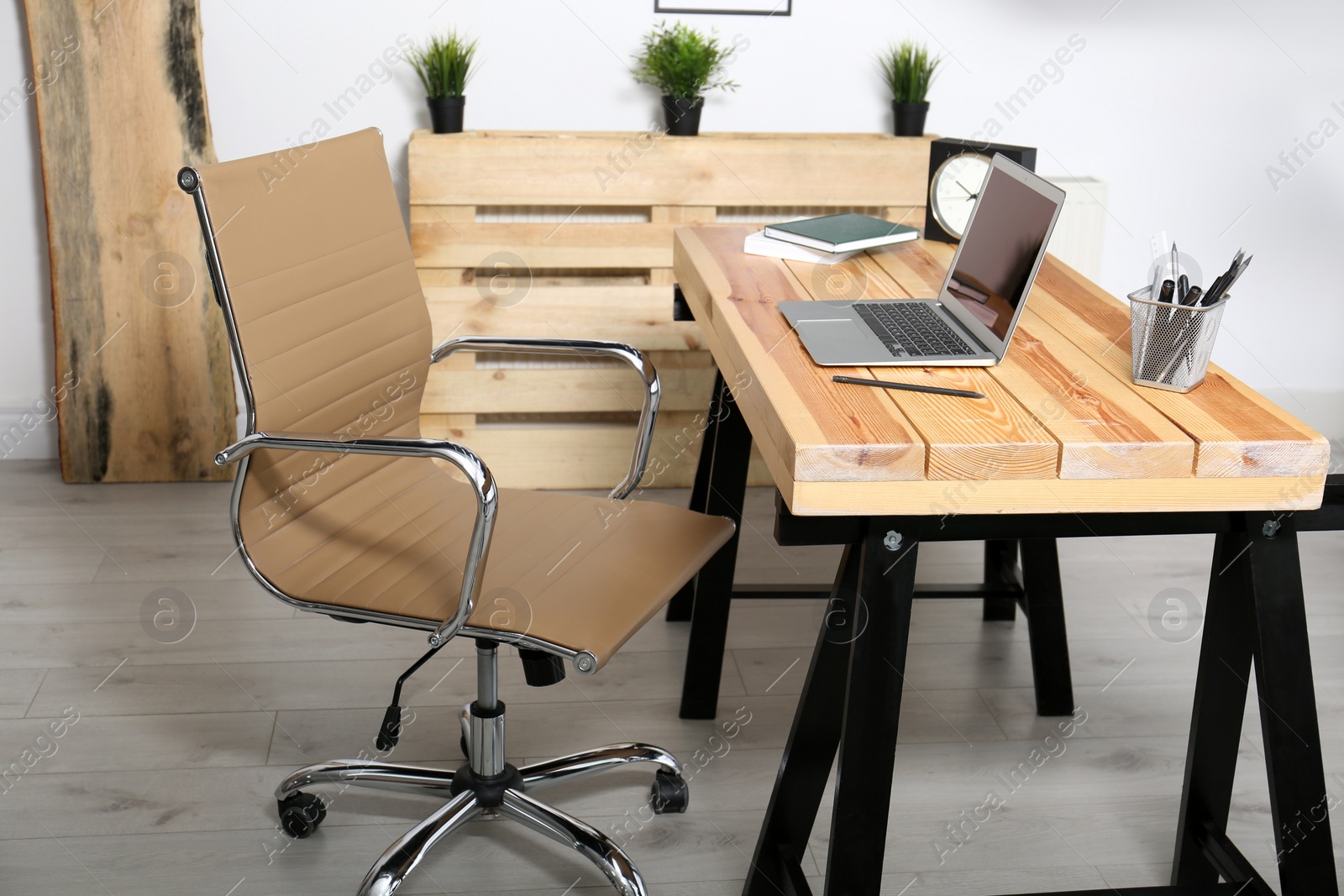 Photo of Comfortable workplace with office chair and wooden table