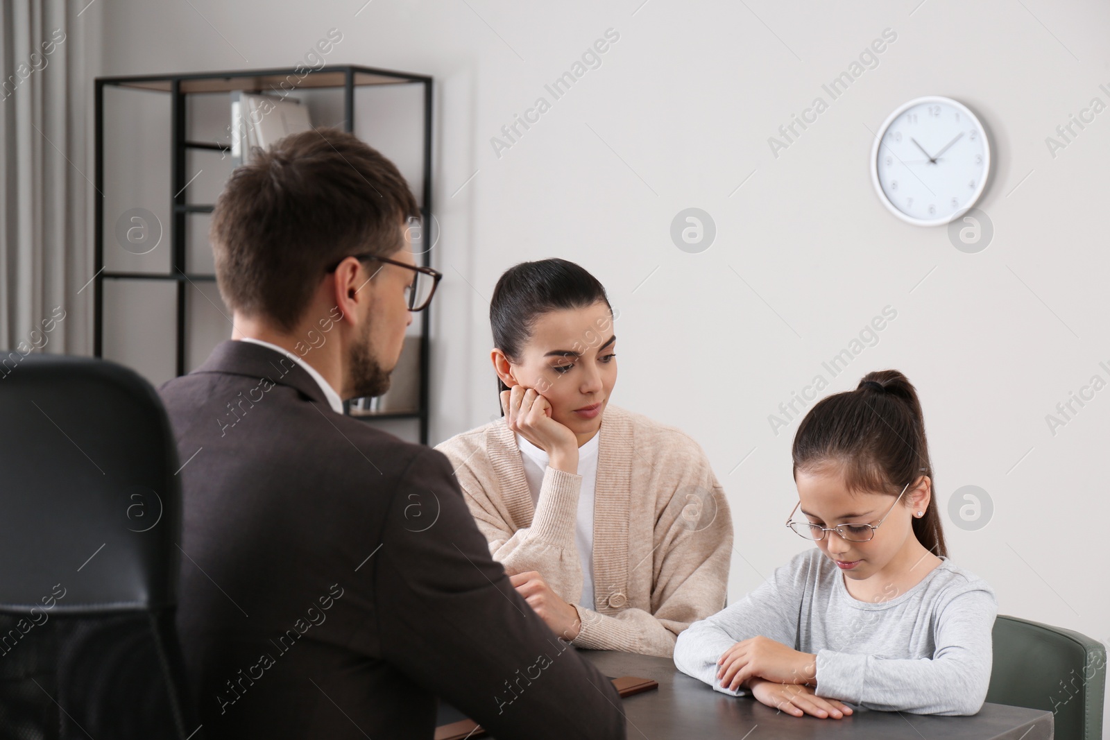 Photo of Mother and daughter having meeting with principal at school