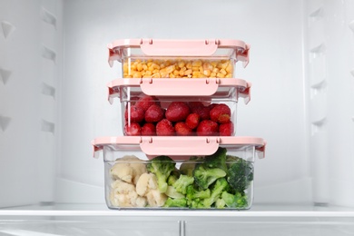 Boxes with different products inside of refrigerator