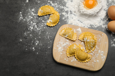 Photo of Flat lay composition with raw ravioli on grey table. Italian pasta