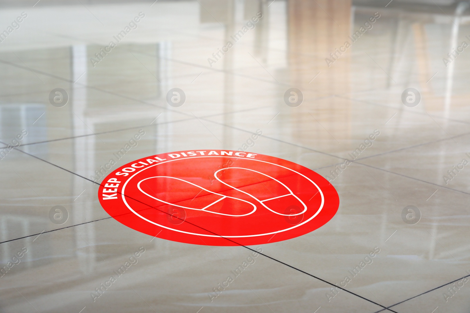 Image of Sign KEEP SOCIAL DISTANCE on floor indoors. Coronavirus pandemic