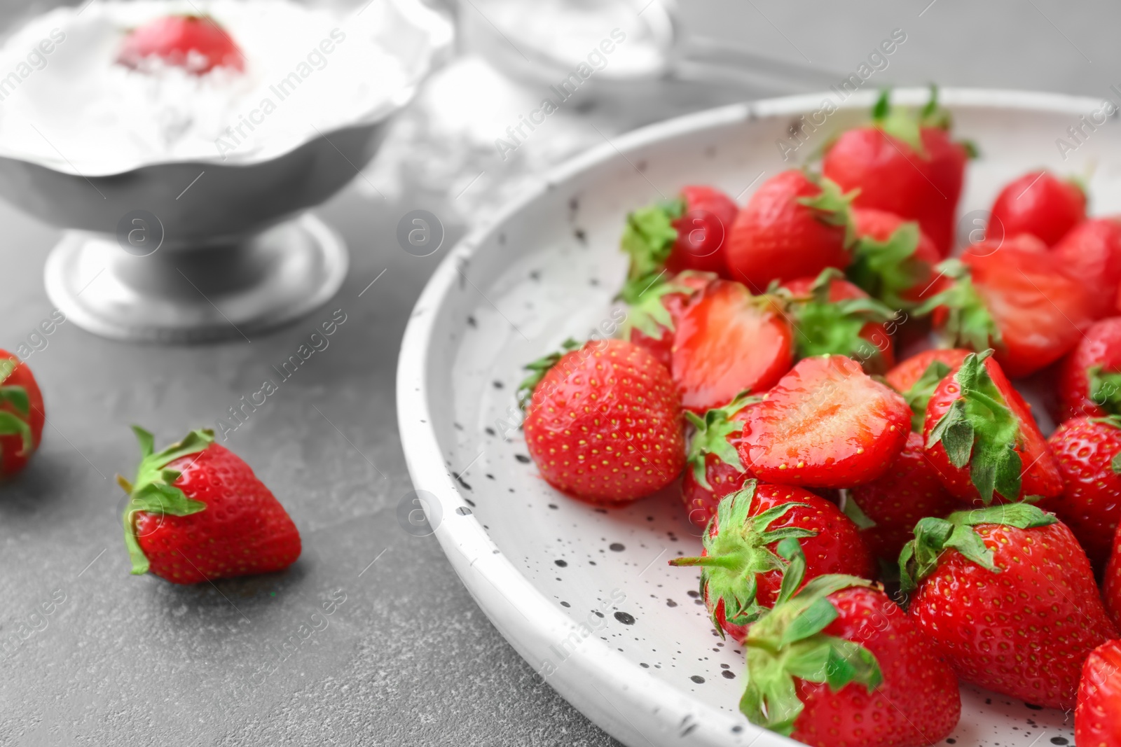 Photo of Plate with ripe red strawberries on table, closeup