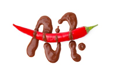 Photo of Red hot chili pepper and stroke of melted chocolate isolated on white, top view
