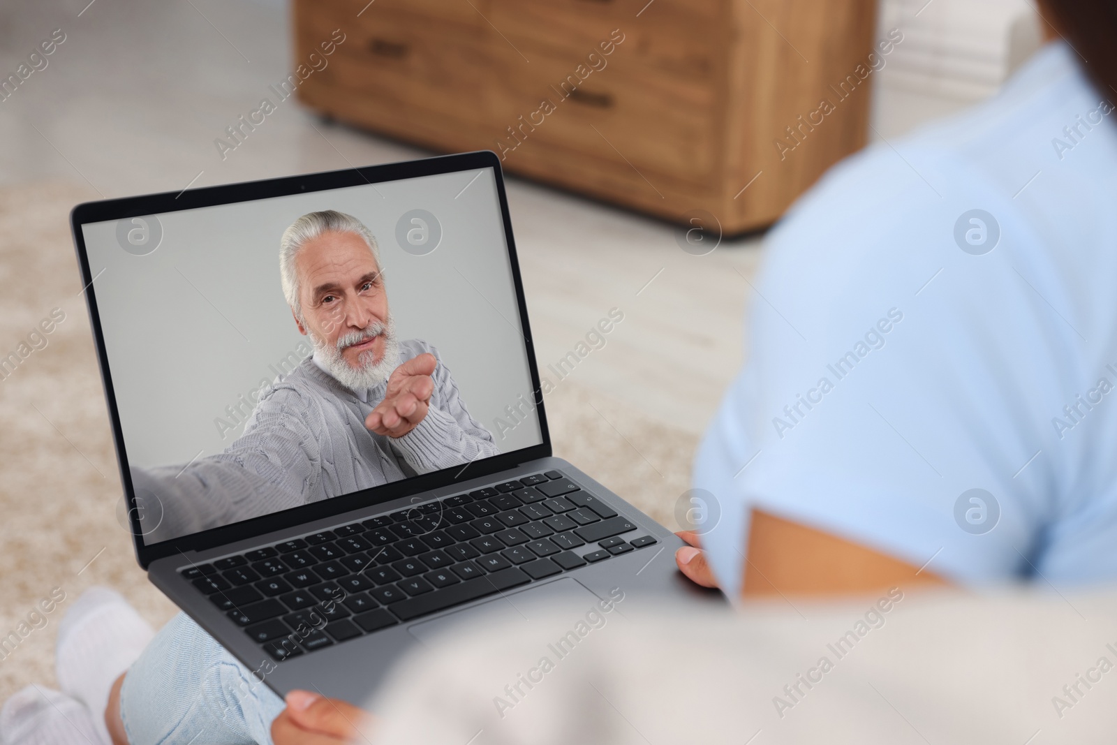 Image of Long distance love. Woman having video chat with her boyfriend via laptop at home, closeup