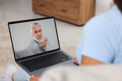 Long distance love. Woman having video chat with her boyfriend via laptop at home, closeup