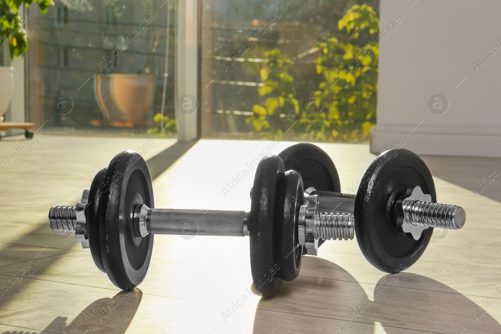 Photo of Pair of adjustable dumbbells on floor indoors