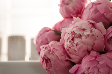 Photo of Bouquet of beautiful fresh pink peonies indoors, closeup