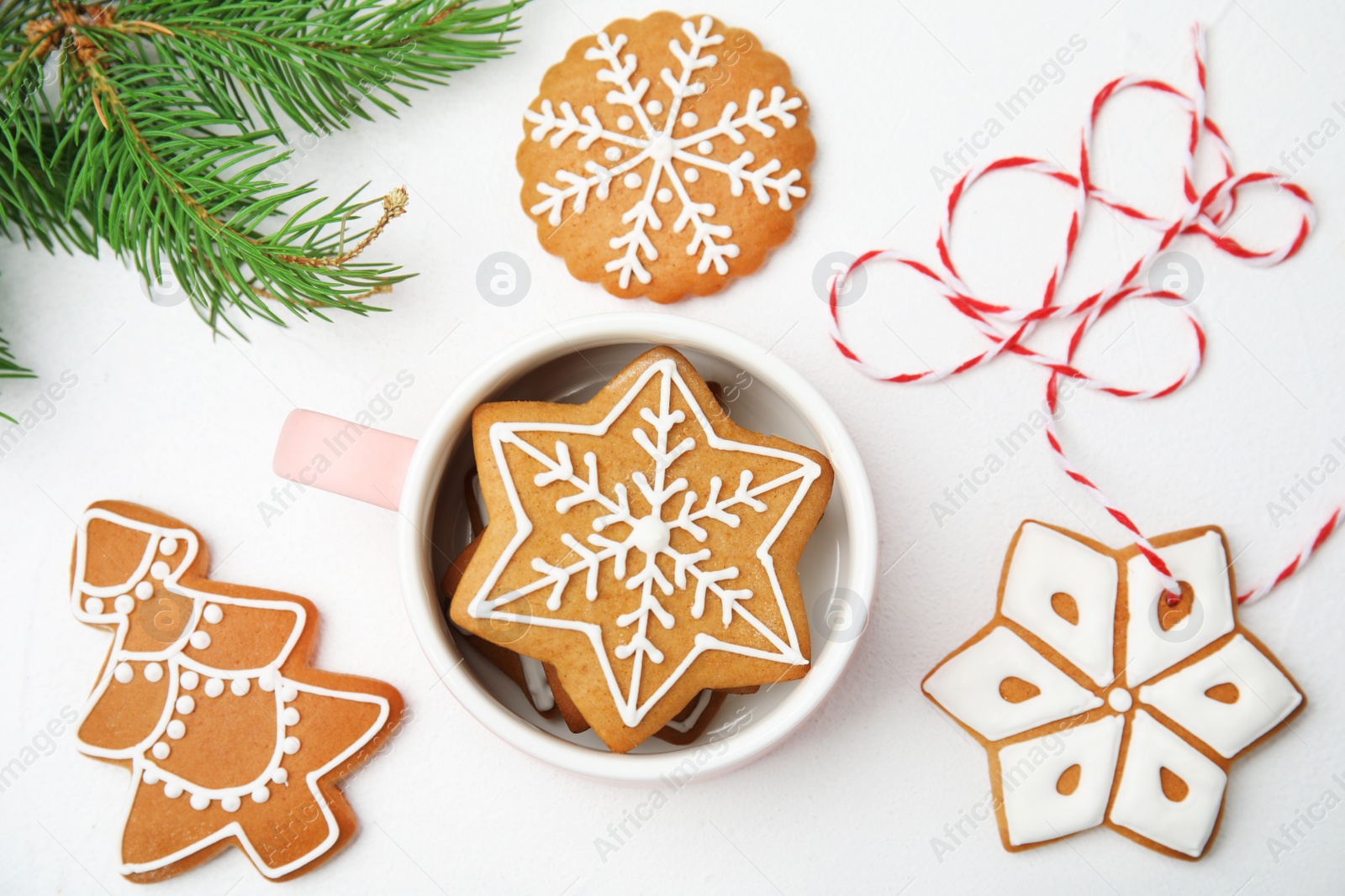 Photo of Cup with tasty homemade Christmas cookies on table, top view