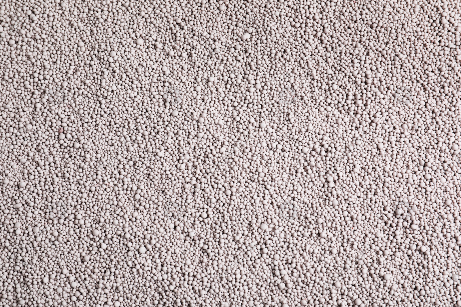 Photo of Textured chemical fertilizer for gardening as background, top view