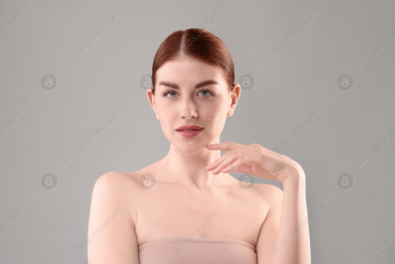 Photo of Portrait of beautiful woman on grey background