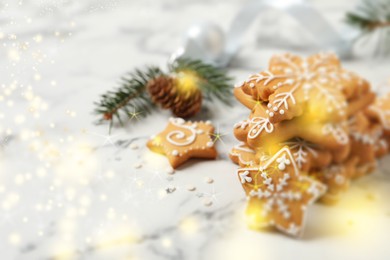Image of Tasty Christmas cookies on white marble table, space for text. Bokeh effect