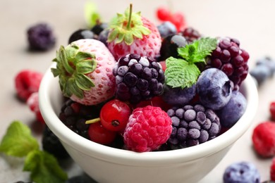 Photo of Mix of different frozen berries in bowl, closeup