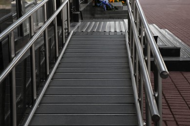 Photo of Ramp with metal railings near building outdoors