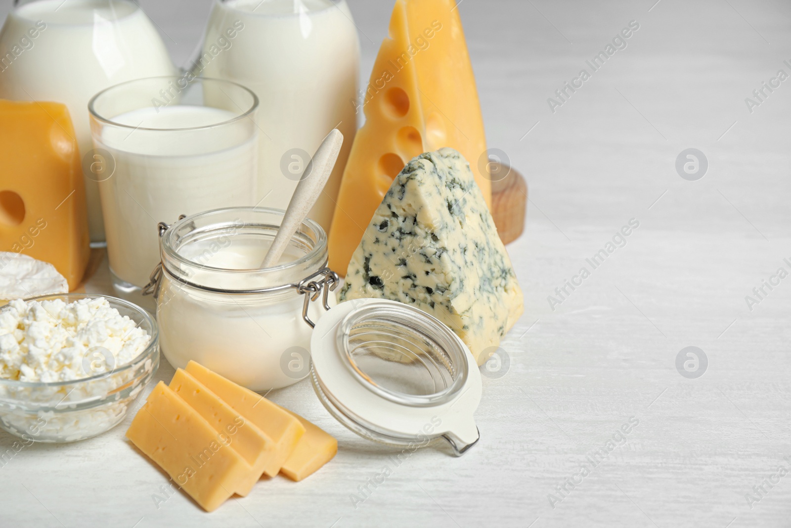 Photo of Different delicious dairy products on white table