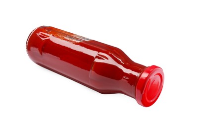 Glass bottle of tasty ketchup isolated on white