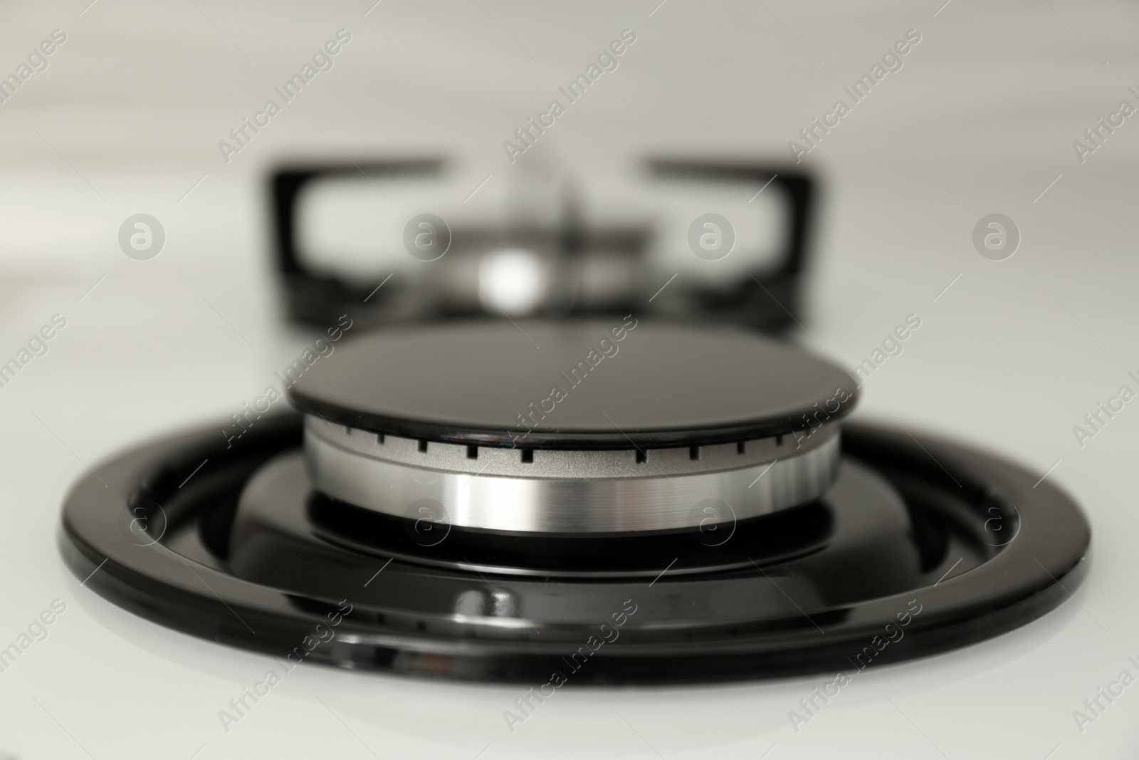 Photo of Modern built-in gas cooktop, closeup. Kitchen appliance