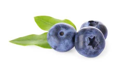 Photo of Tasty ripe fresh blueberries and green leaves on white background