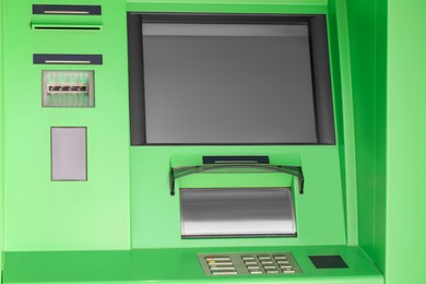 Photo of Modern automated cash machine with screen outdoors