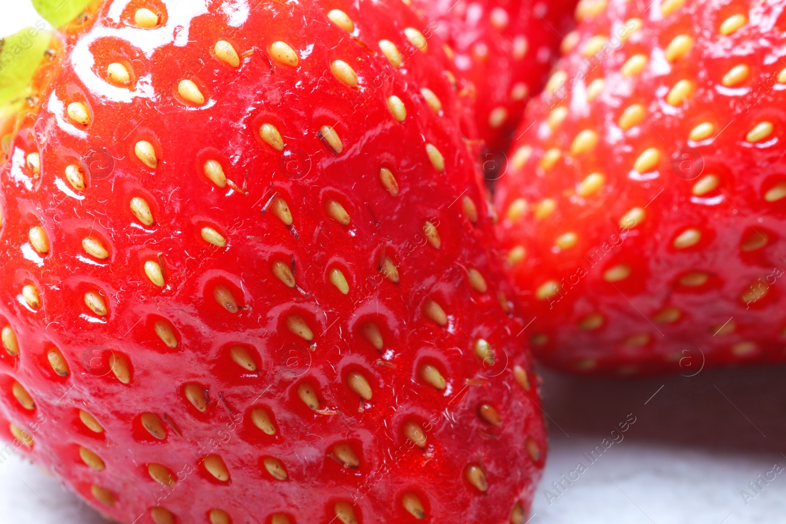 Photo of Fresh ripe strawberries on light table, closeup