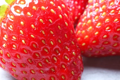 Photo of Fresh ripe strawberries on light table, closeup