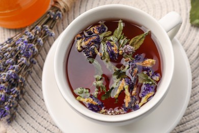 Aromatic tea with different dry herbs on table, top view