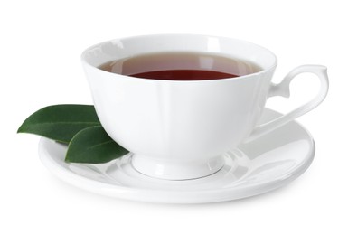 Aromatic tea in cup and green leaves isolated on white