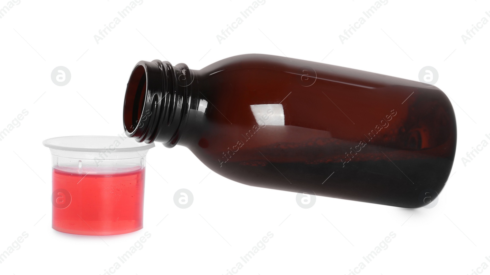 Photo of Bottle of cough syrup and measuring cup on white background