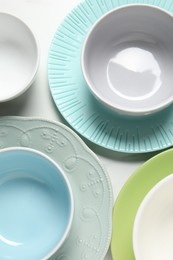 Beautiful ceramic dishware on white table, flat lay