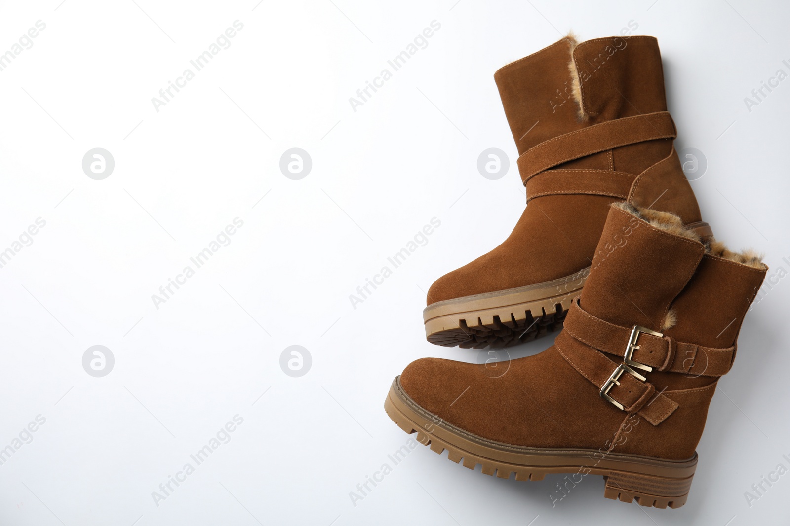 Photo of Stylish brown boots on white background, top view. Space for text